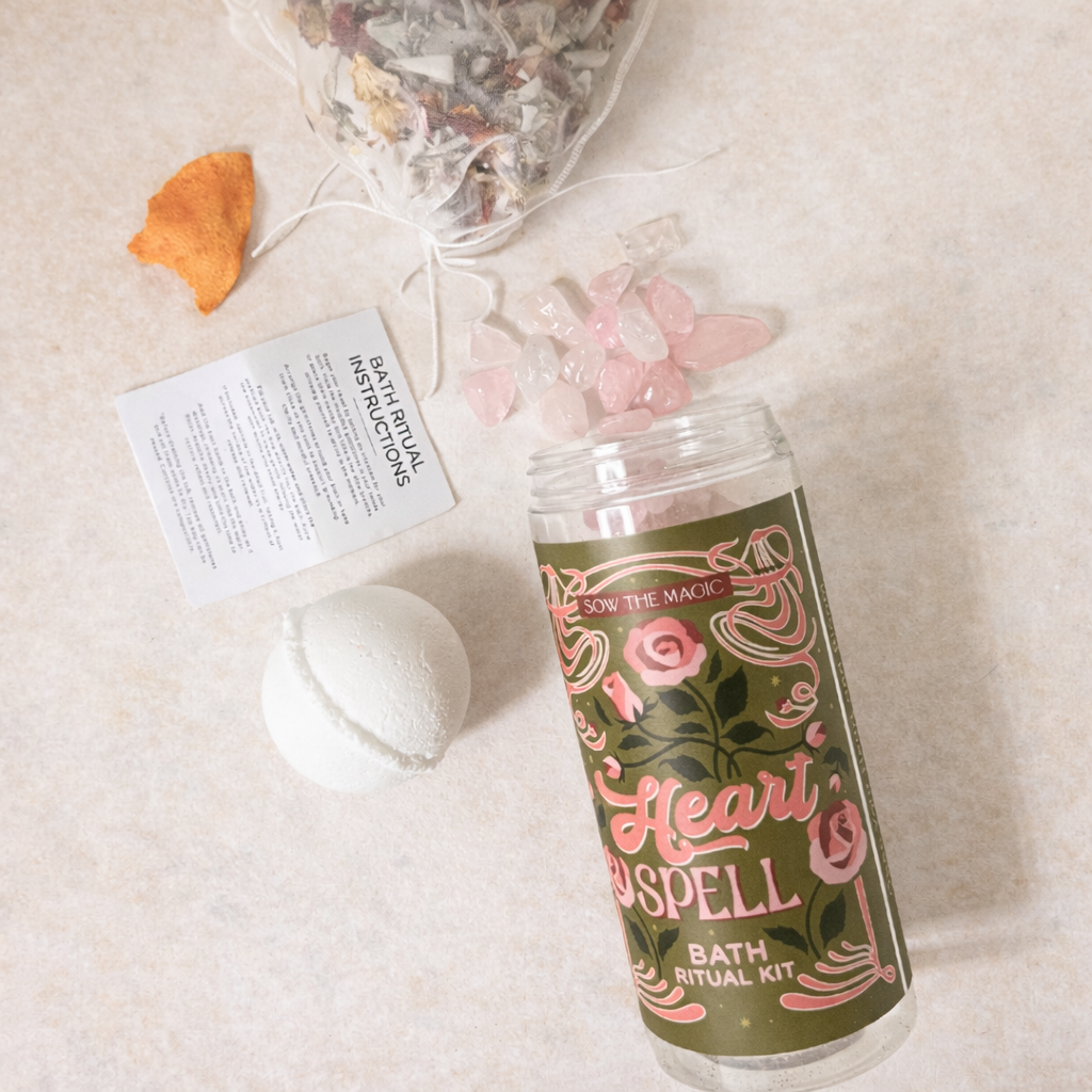 Heart Spell Bath Ritual Kit styled on a neutral background with rose quartz, bath bomb, botanical tea and dried citrus