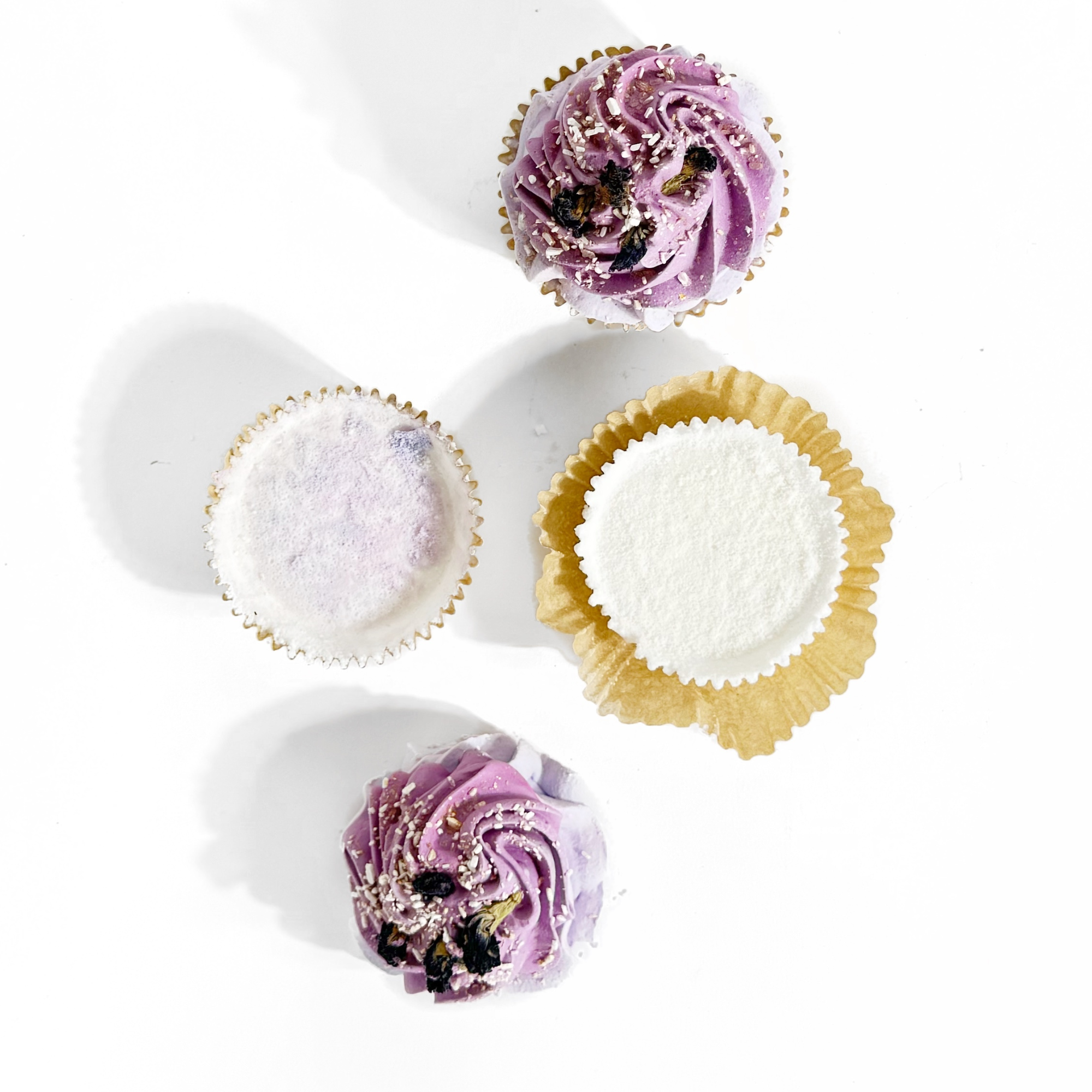 Top view of Lavender Mint Cupcake Bath Bombs showing purple frosting and unwrapped fizzy bases