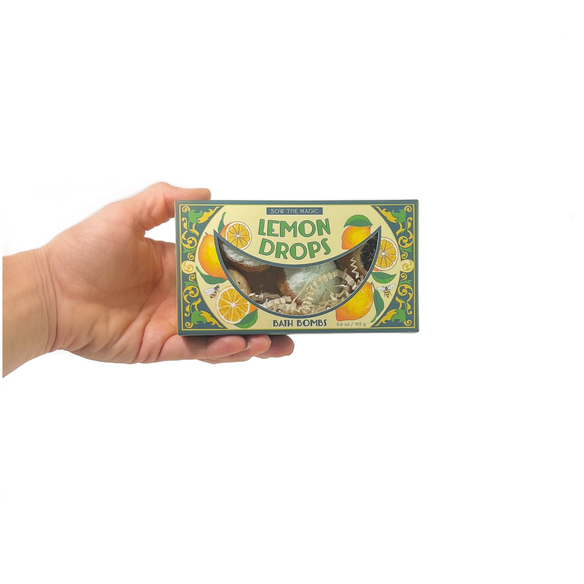 Hand holding Lemon Drop Bath Bomb Gift Set showing illustrated citrus packaging and compact box design