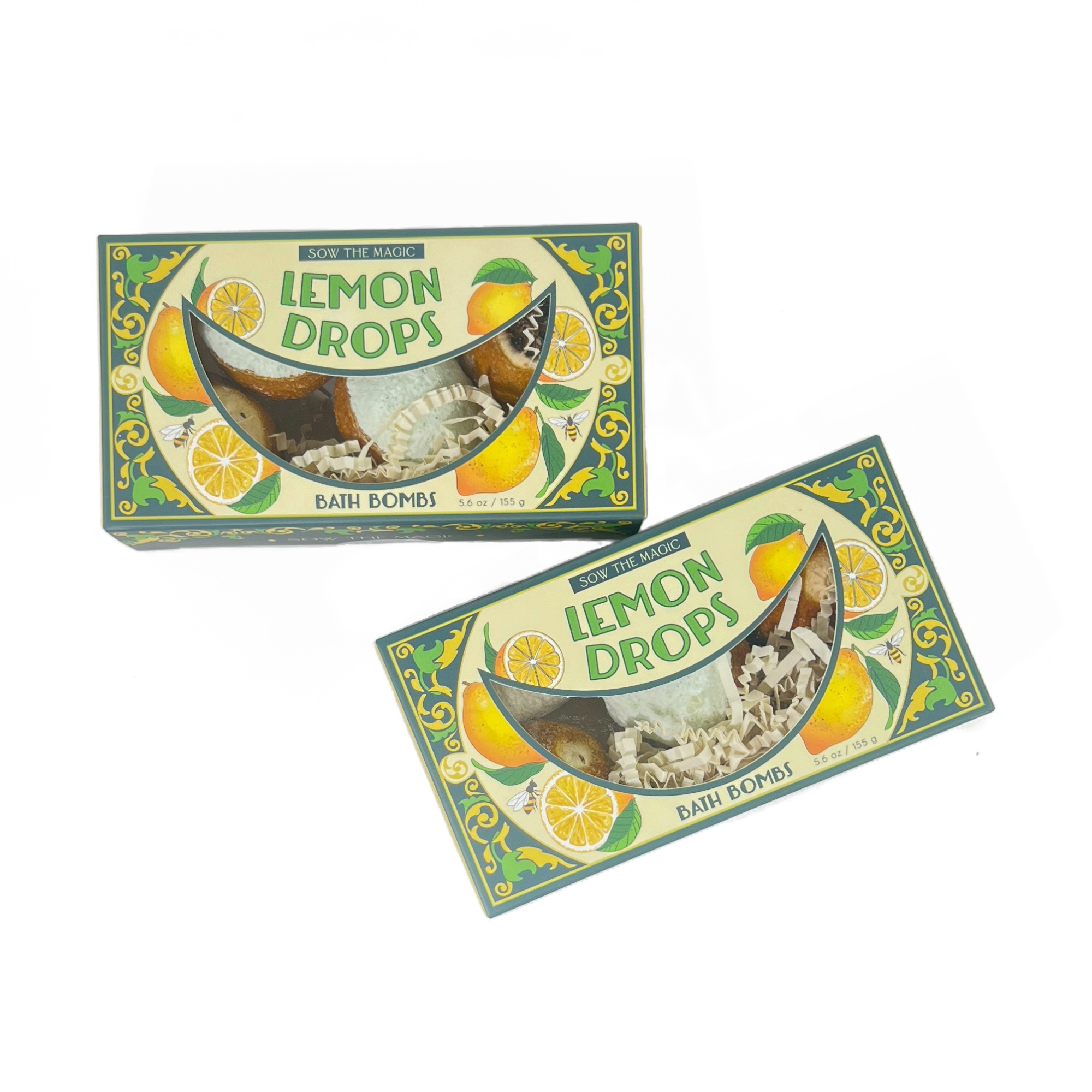 Two Lemon Drop Bath Bomb Gift Set boxes stacked at angles showcasing yellow and green botanical design