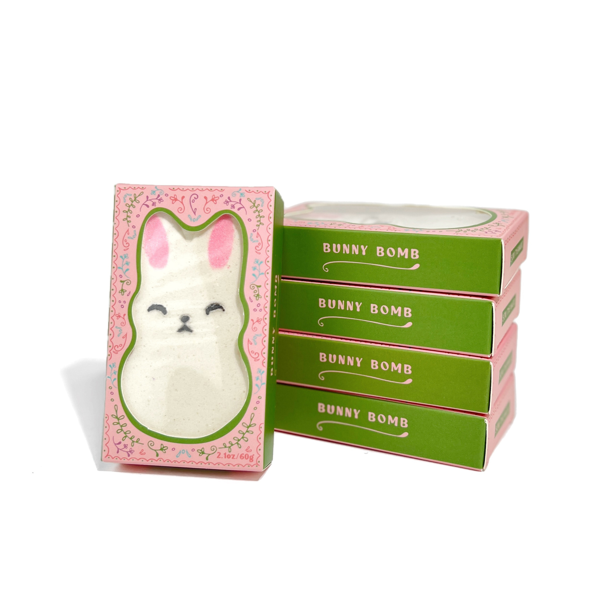 Stack of boxed Little Bunny Strawberry Bath Bombs with pastel packaging with one open 