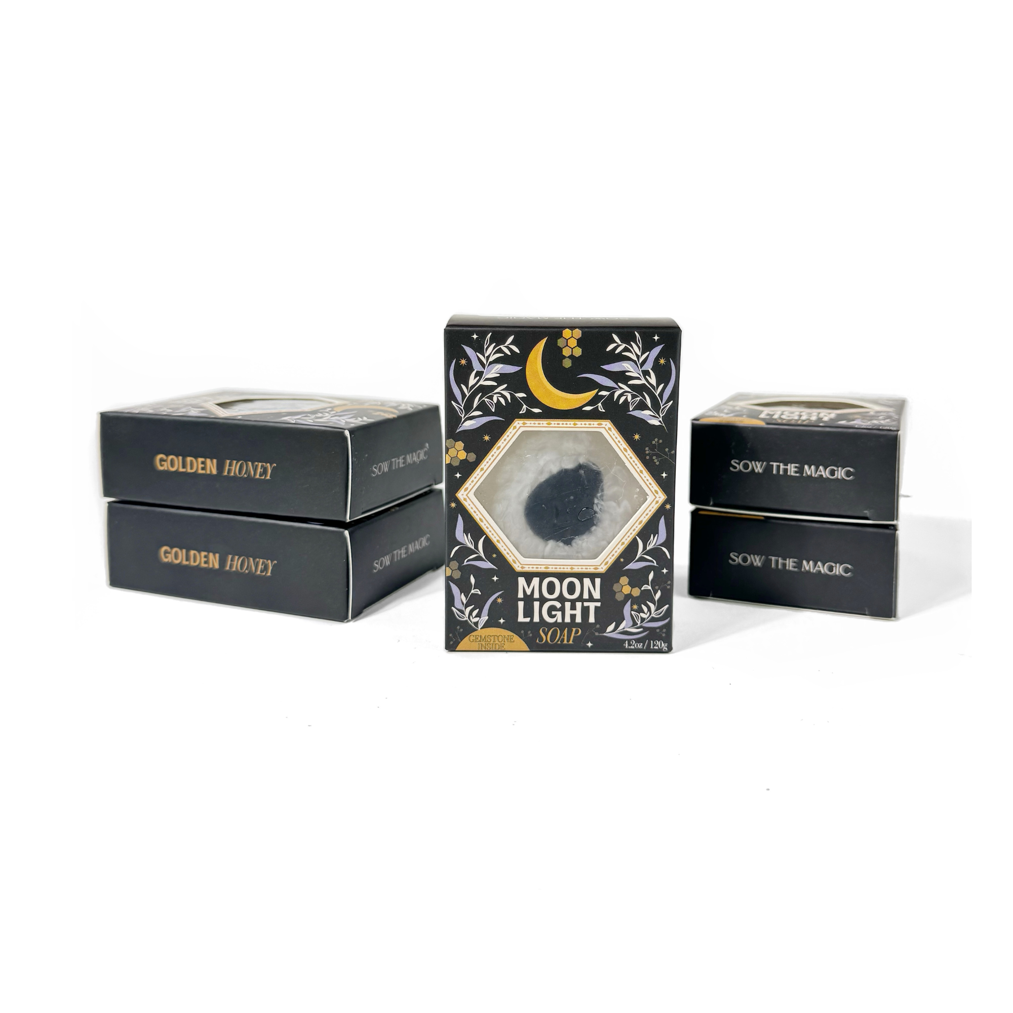 Moonlight Gemstone Soaps stacked beside boxes labeled Golden Honey, showing elegant black and gold packaging.