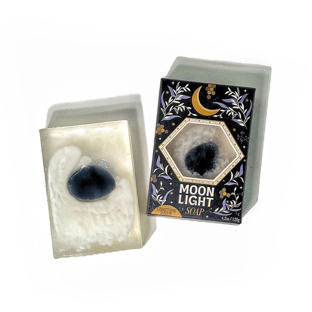 Moonlight Gemstone Soap shown unboxed beside packaging, displaying embedded obsidian gemstone in translucent soap bar.
