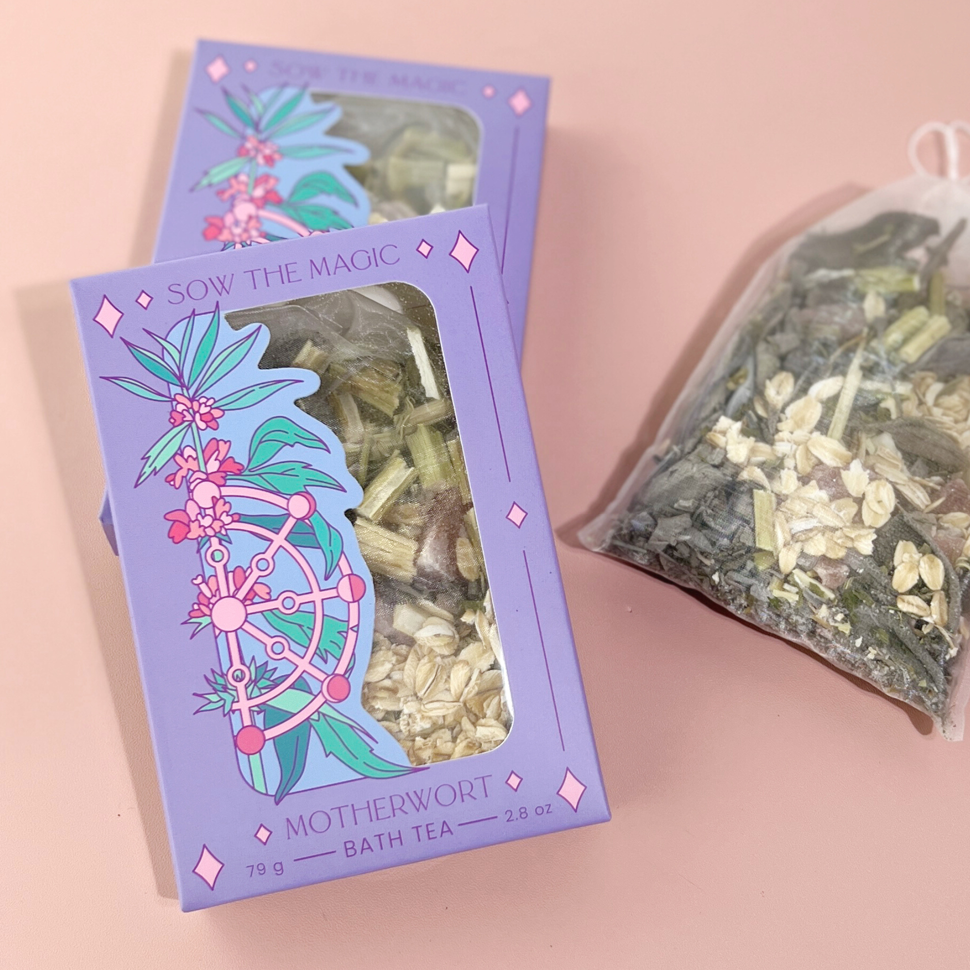 Two Motherwort Bath Tea Boxes by Sow the Magic beside an herbal tea bag on blush background.