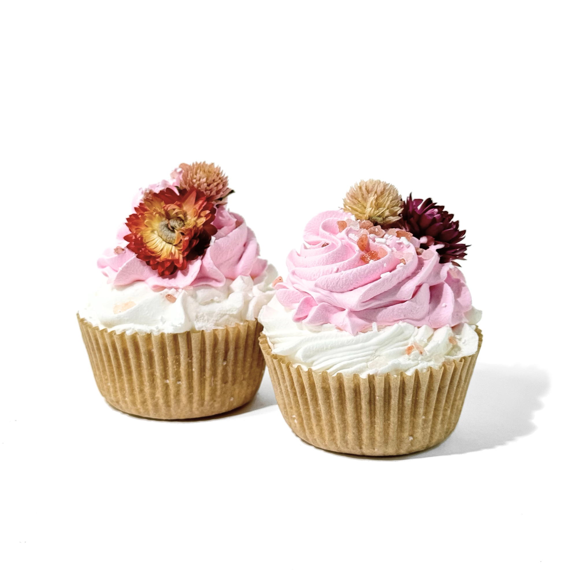 Two pink and white Peppermint Flowers Cupcake Bath Bombs topped with dried blooms and Himalayan salt