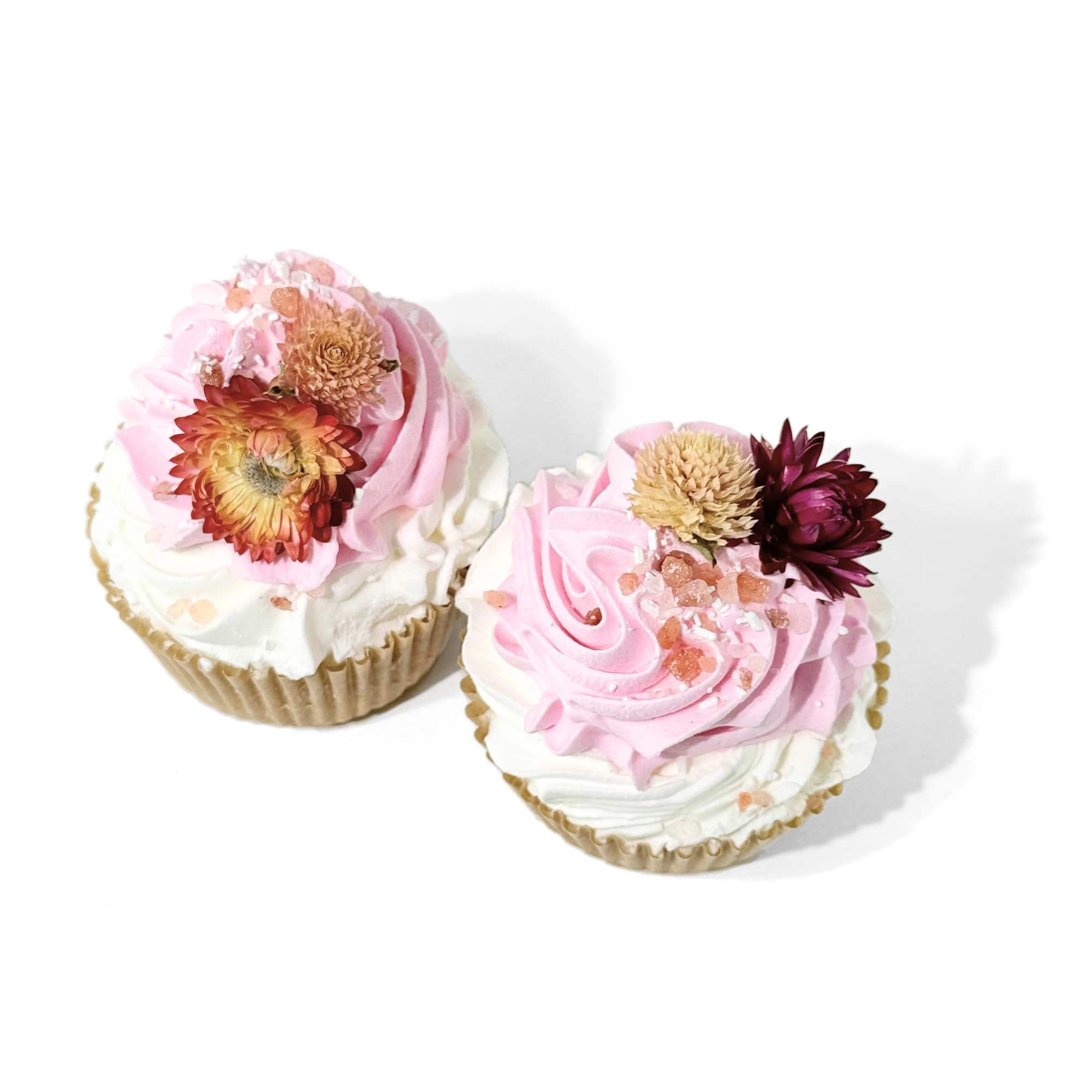 Top view of Peppermint Flowers Cupcake Bath Bombs decorated with pink frosting and dried blossoms