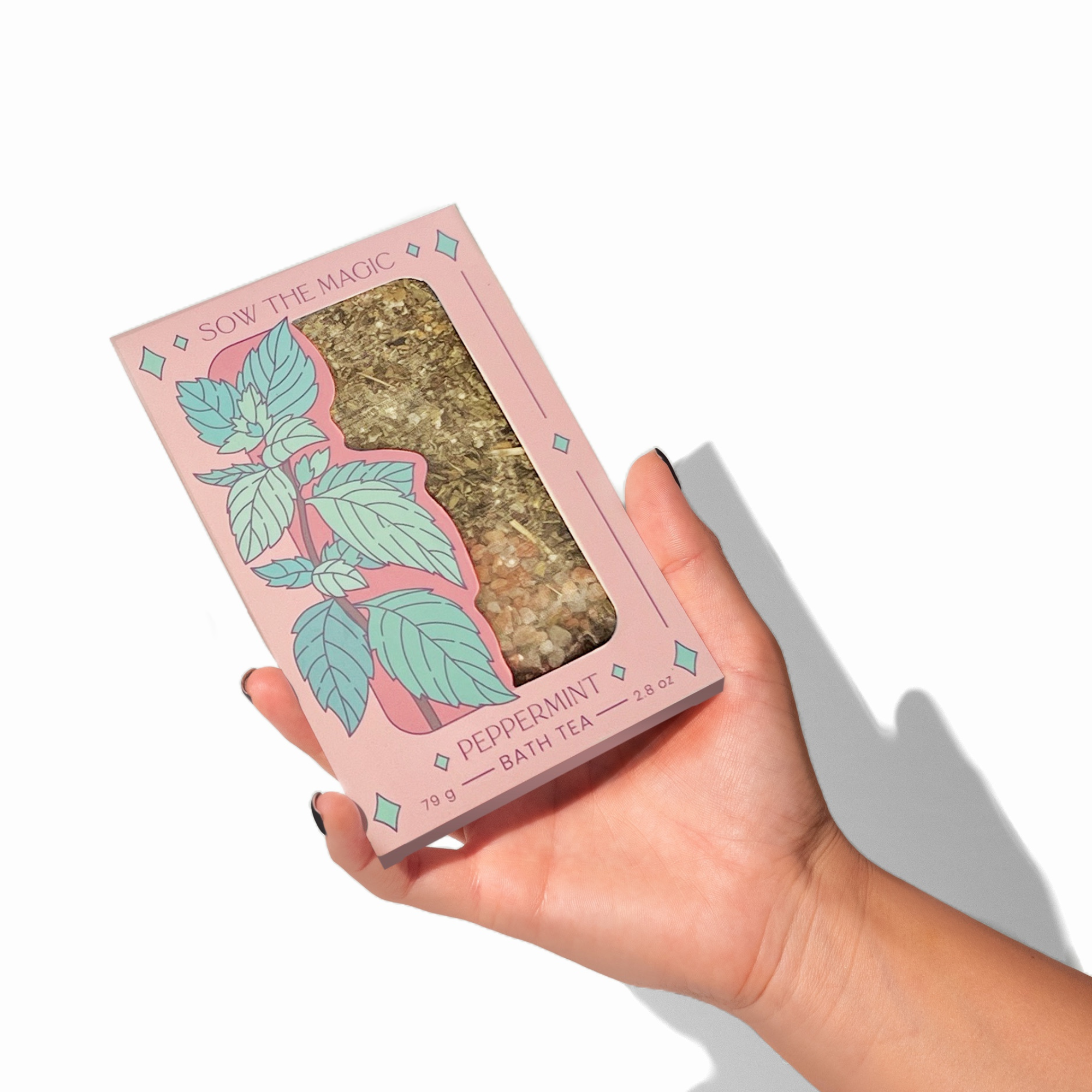Hand holding Peppermint Tarot Botanical Bath Tea Box by Sow the Magic showing detailed mint leaf artwork and natural tea blend.