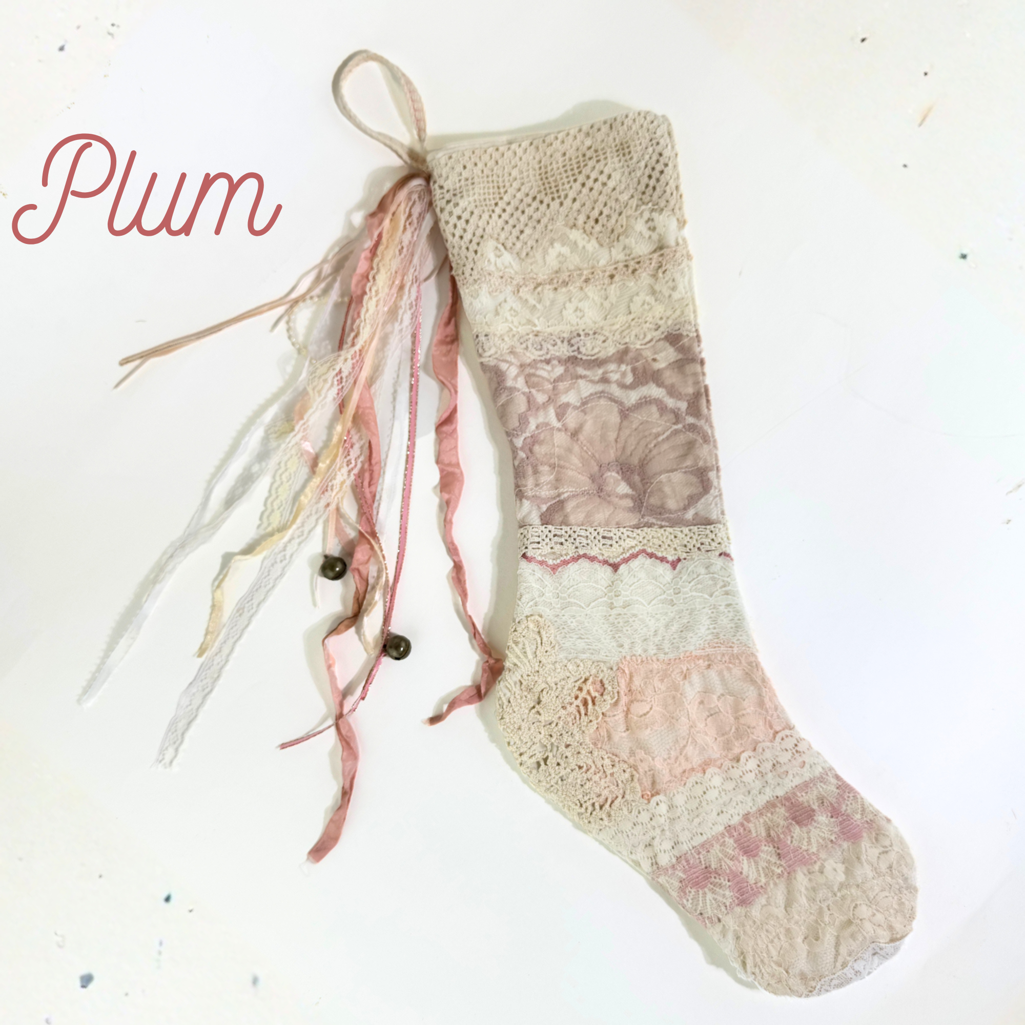 Handmade lace Christmas stocking with mauve and cream patchwork lace and ribbon tassels