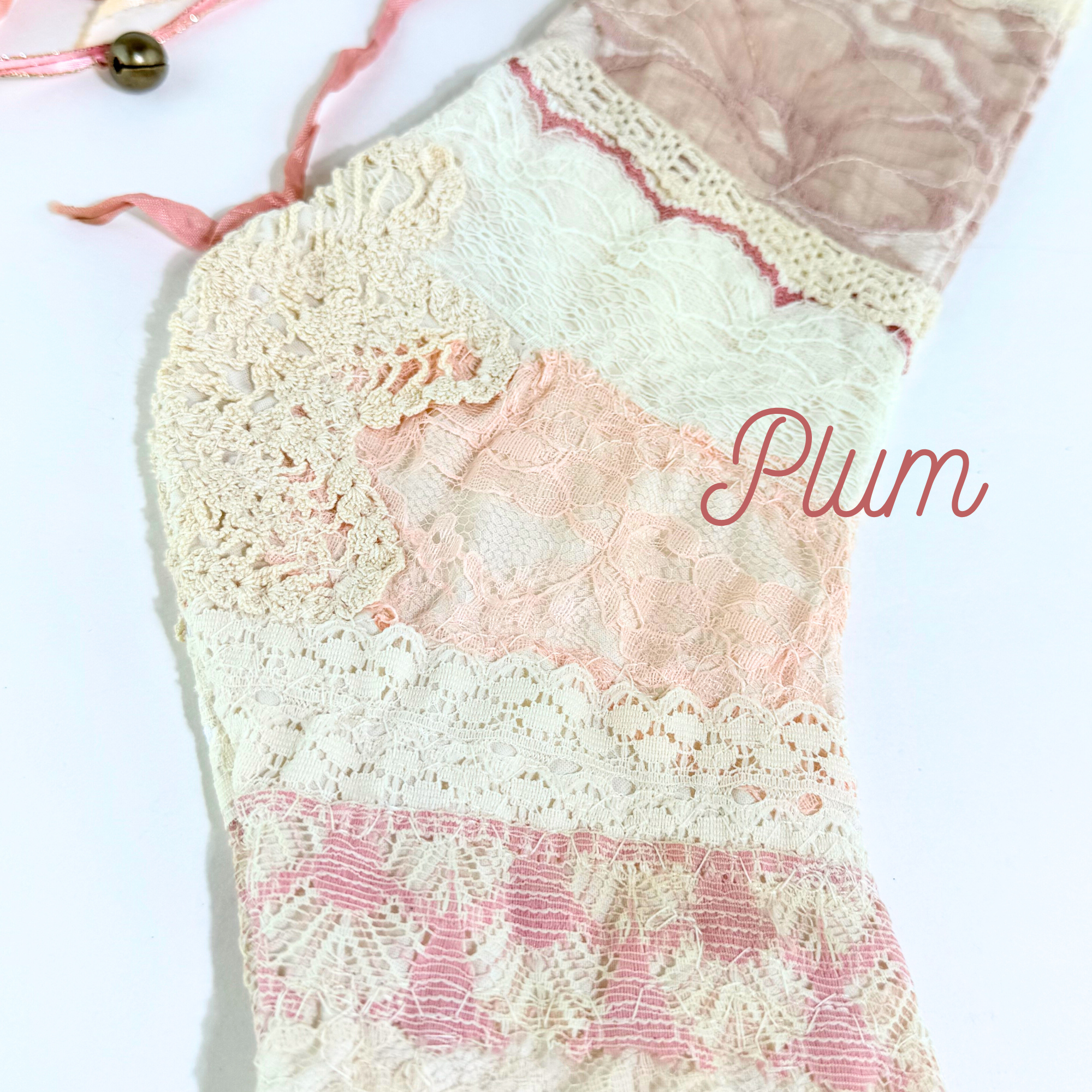 Close-up of stocking toe showing pink lace panels, crochet details, and delicate vintage patchwork