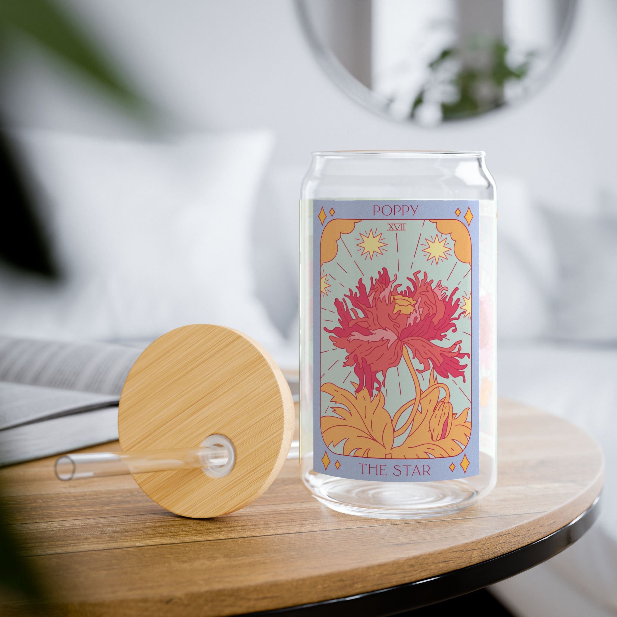 Poppy The Star tarot-inspired glass tumbler styled on a table with bamboo lid and straw