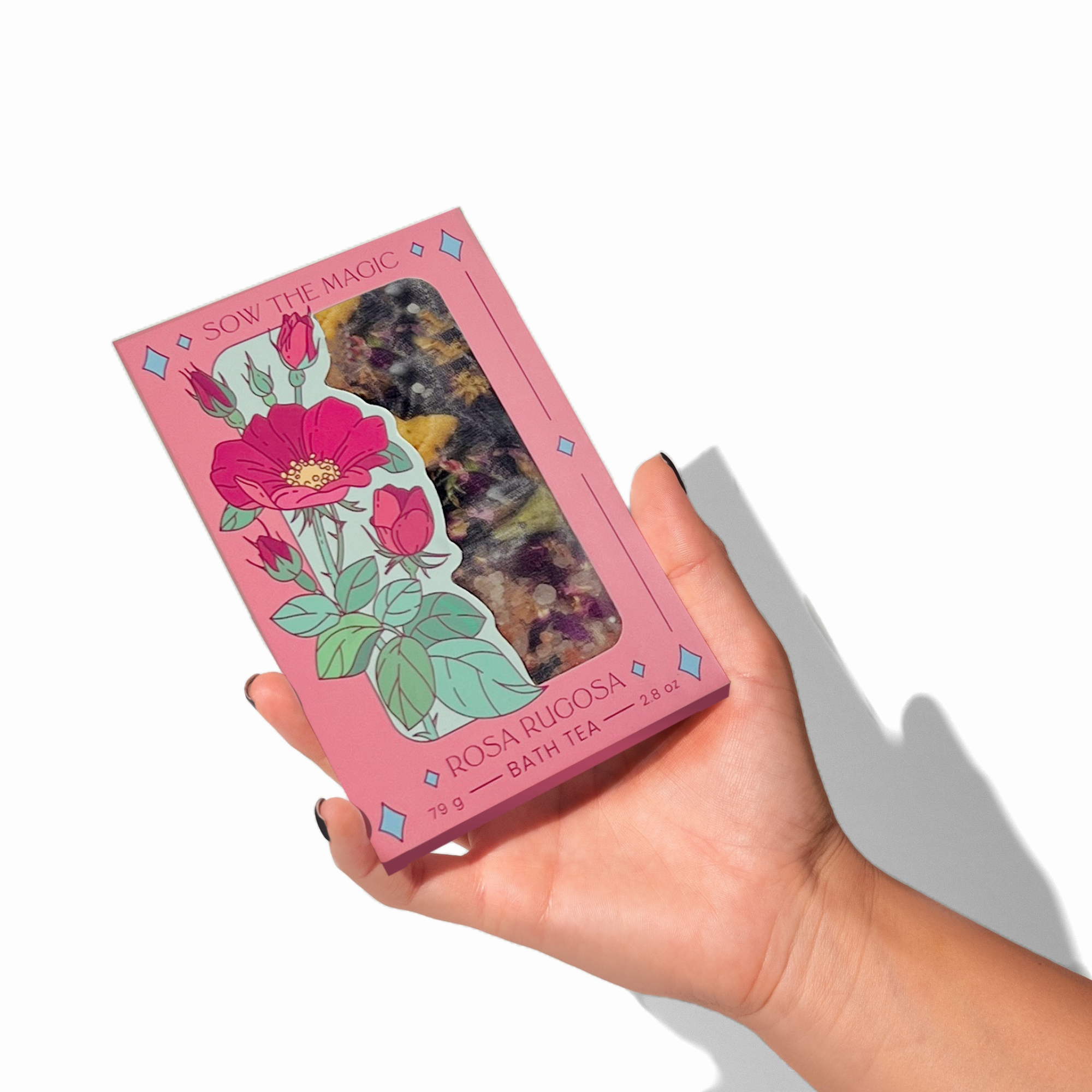 Hand holding Rosa Rugosa Tarot Botanical Bath Tea Box by Sow the Magic showing detailed rose illustration and window packaging.