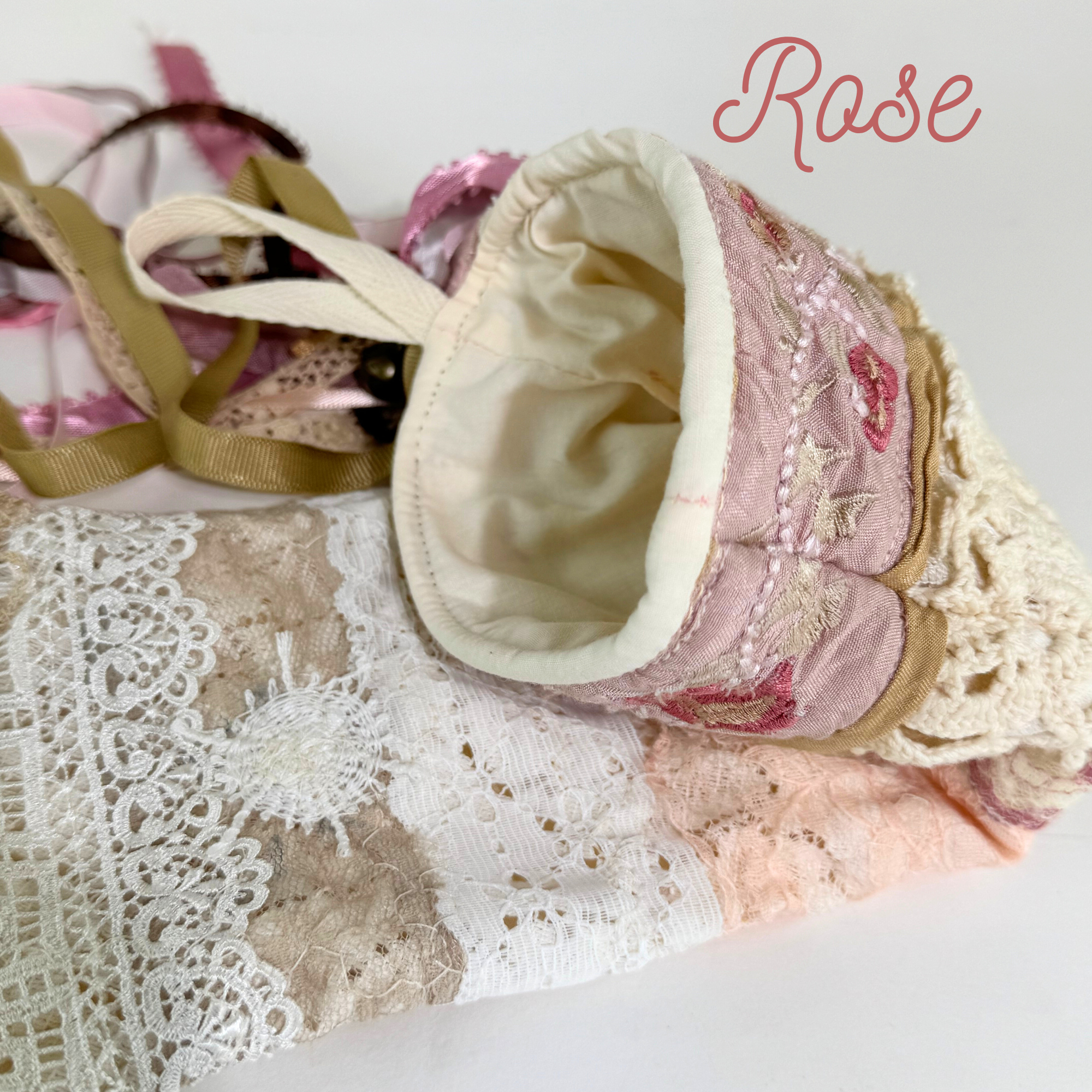 Handmade lace Christmas stocking interior view showing cream cotton lining and blush ribbon tassels
