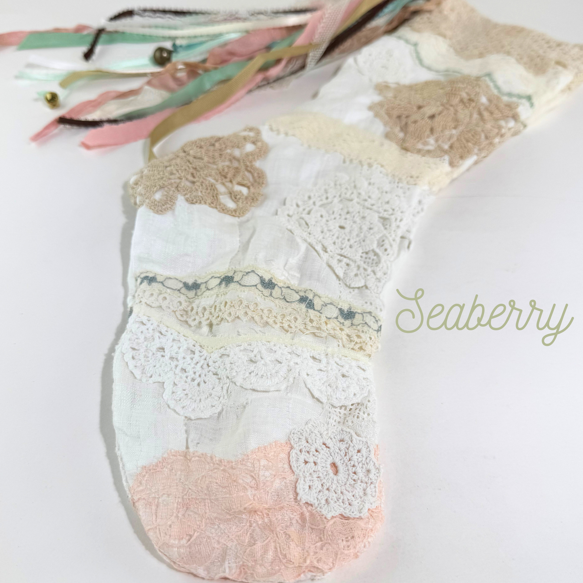 Lace Christmas stocking toe with peach and ivory crochet lace layers and delicate coastal-inspired texture