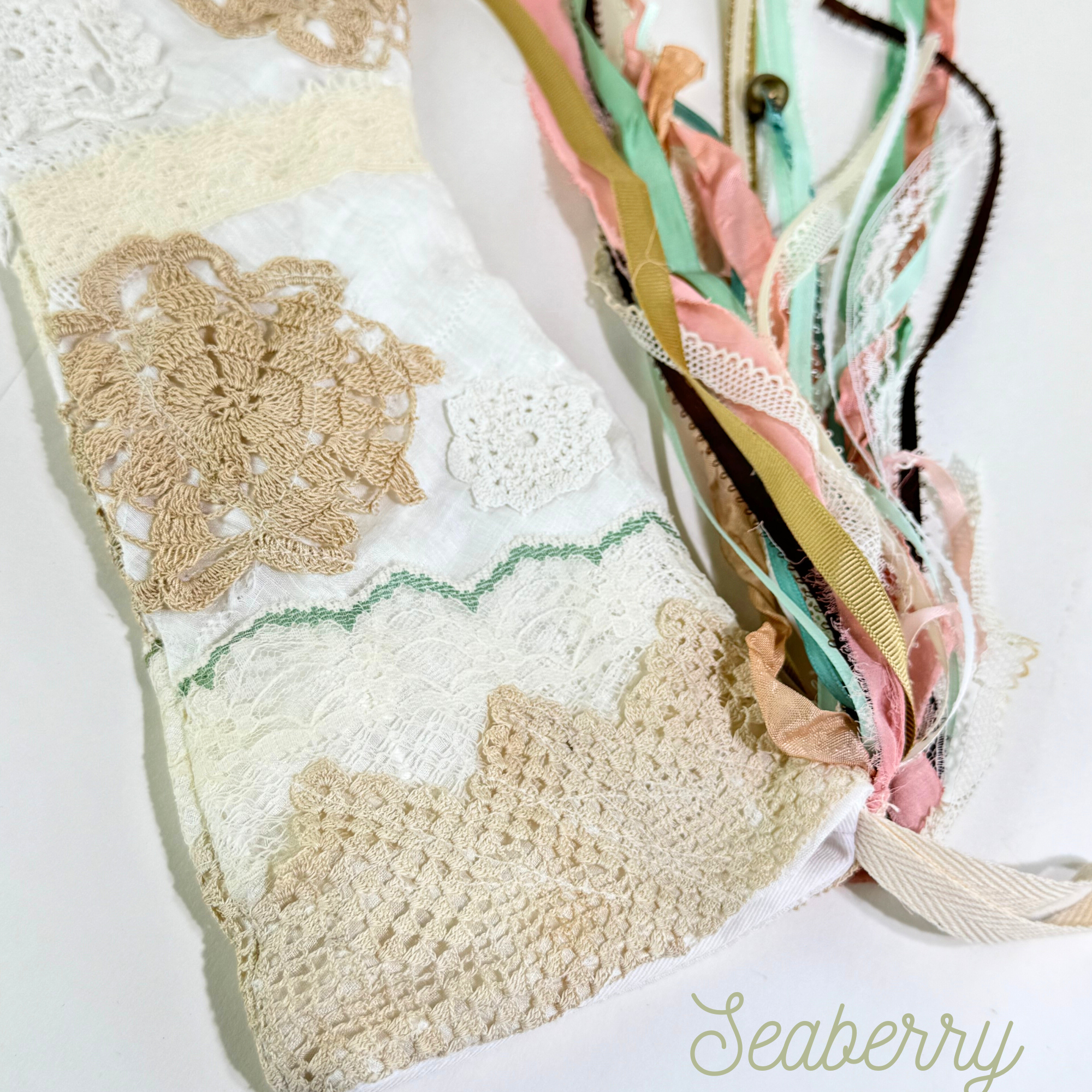 Top of handmade lace Christmas stocking with crochet trim, mint lace accent, and multicolor ribbon tassels