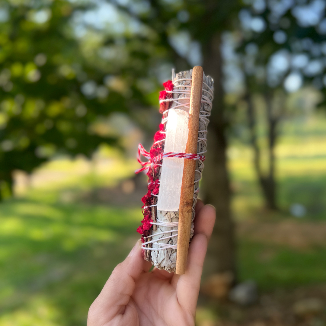holding holiday smudge stick outdoors for spiritual cleansing ritual holiday gift