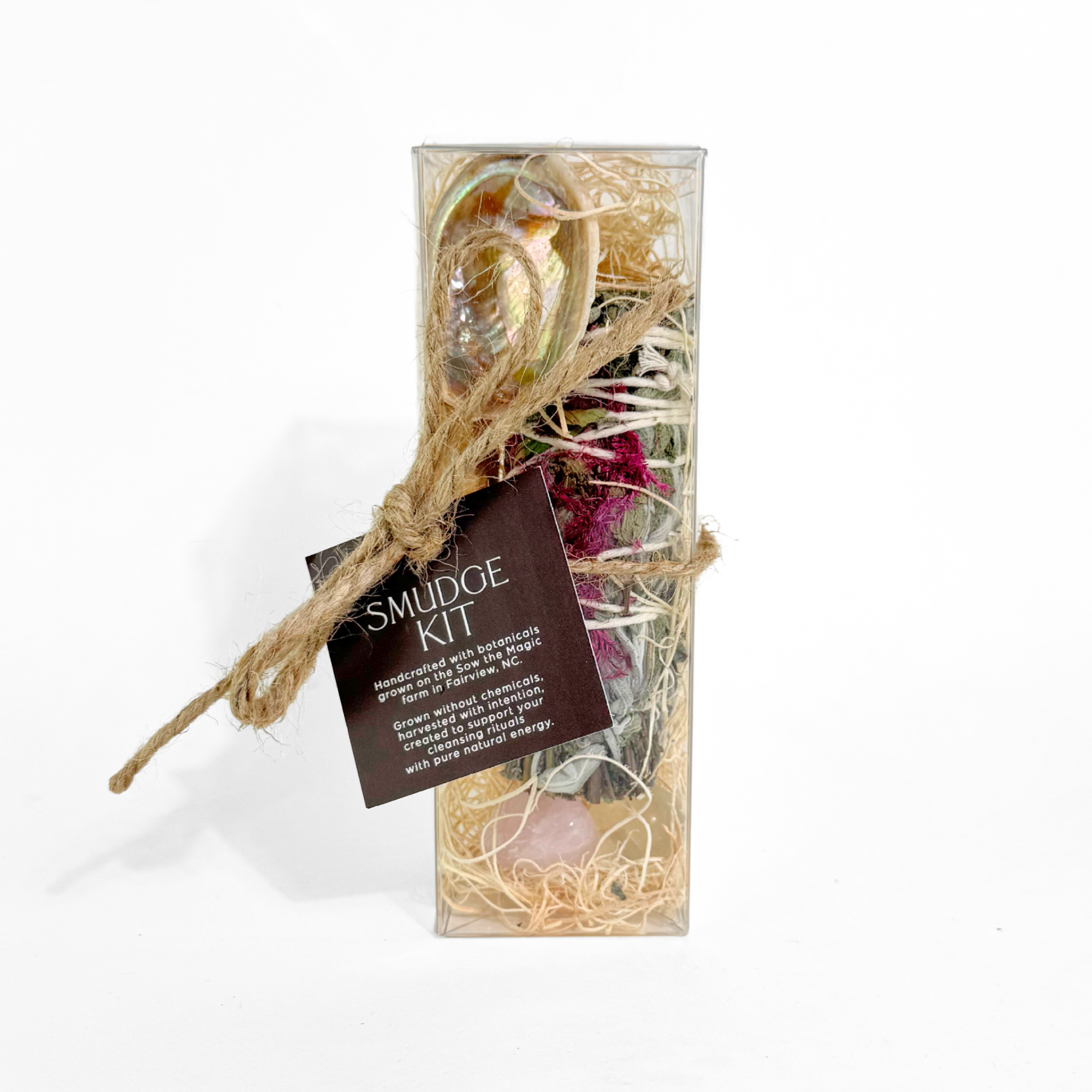 Front view of smudge kit featuring botanical smudge stick abalone shell palo santo and gemstones.