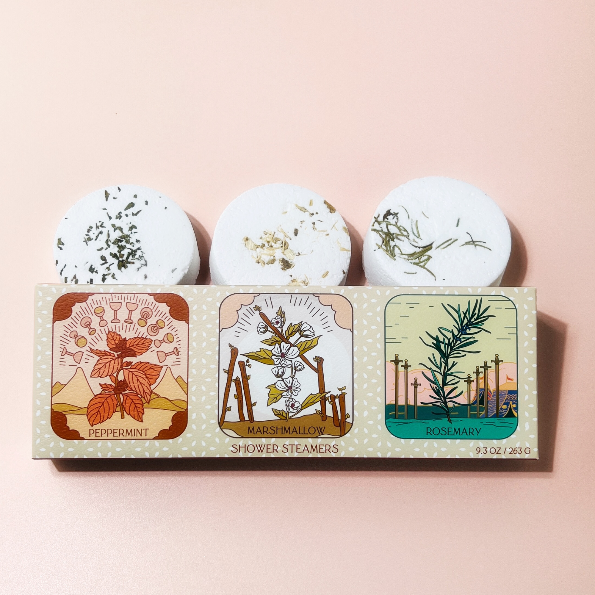 Three tarot shower steamers with natural botanicals paired with matching tarot-inspired packaging