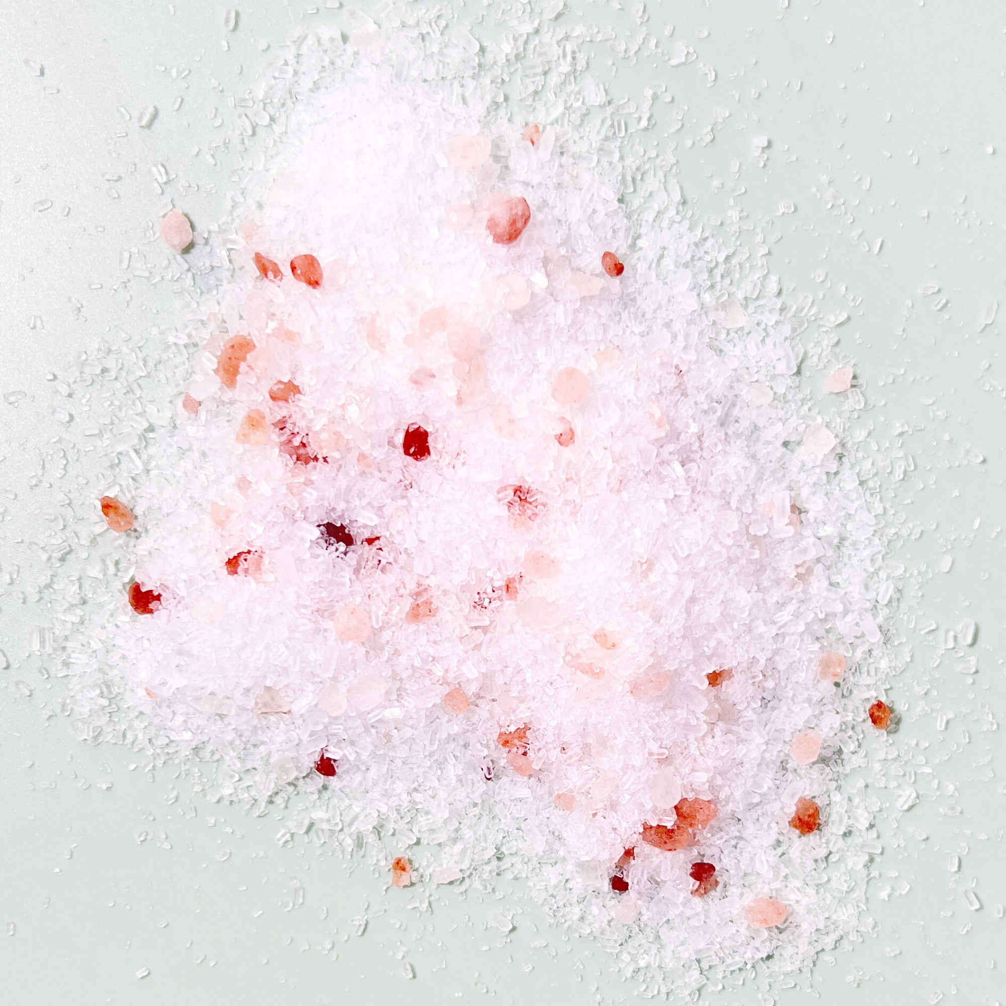 Close-up of pink Himalayan and white mineral bath salts used in Sow the Magic tarot salt soak blends