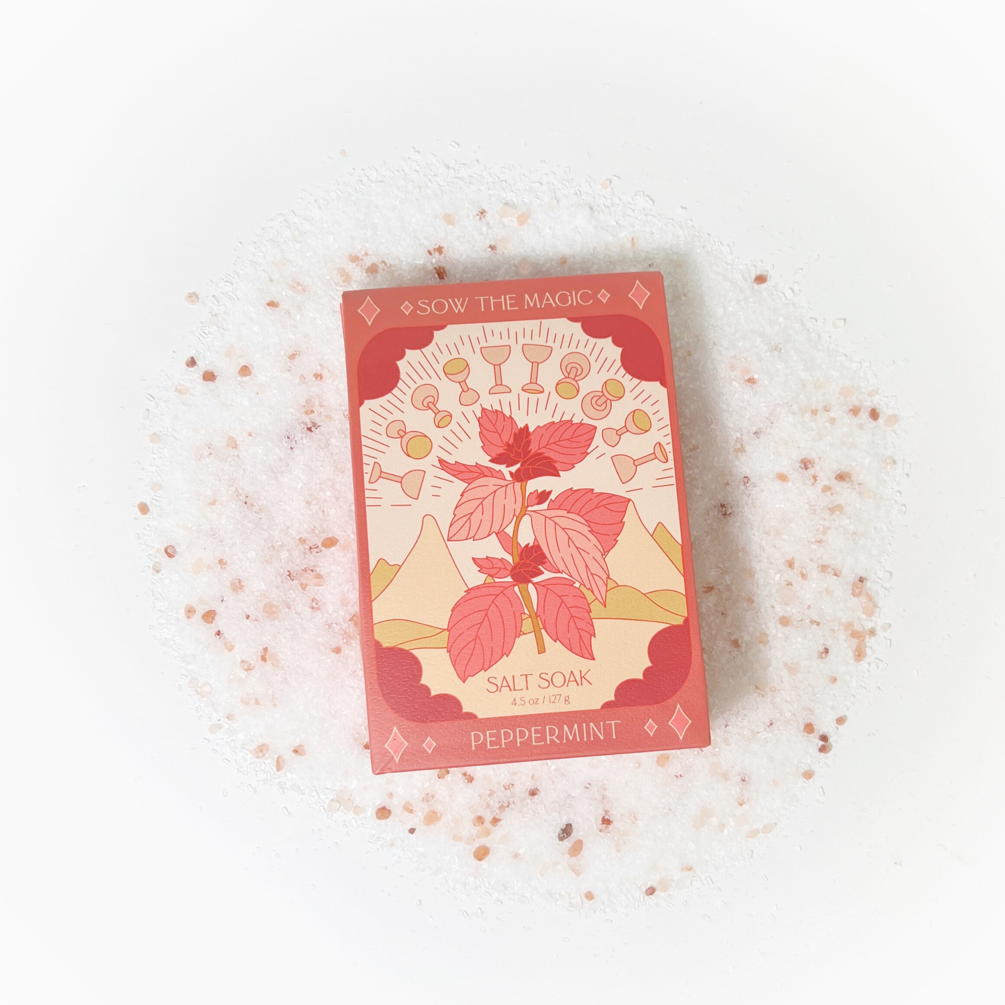 Peppermint Salt Soak tarot box resting on a circular bed of pink Himalayan bath salt crystals