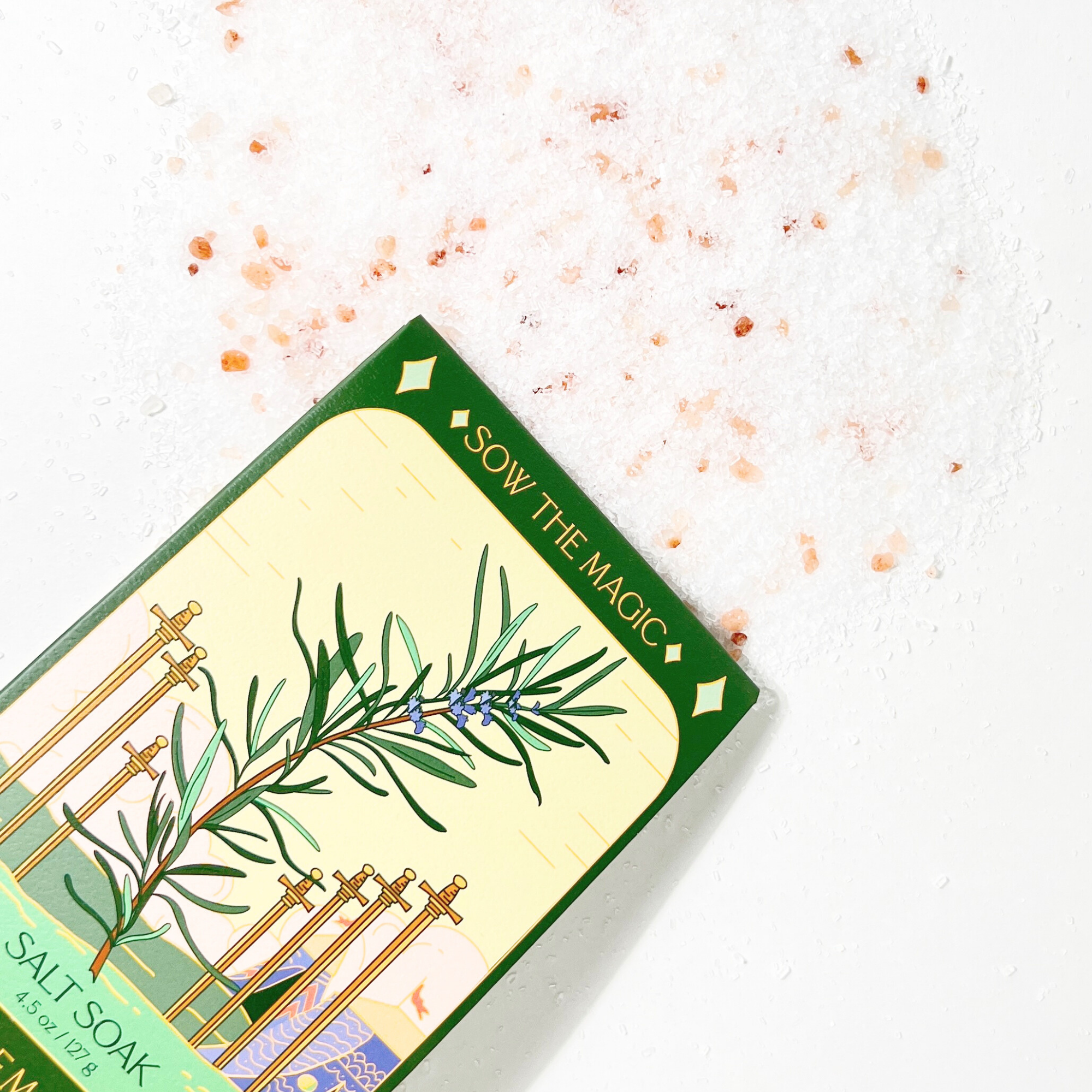 Rosemary Salt Soak tarot box lying on white background surrounded by pink Himalayan and sea salt crystals