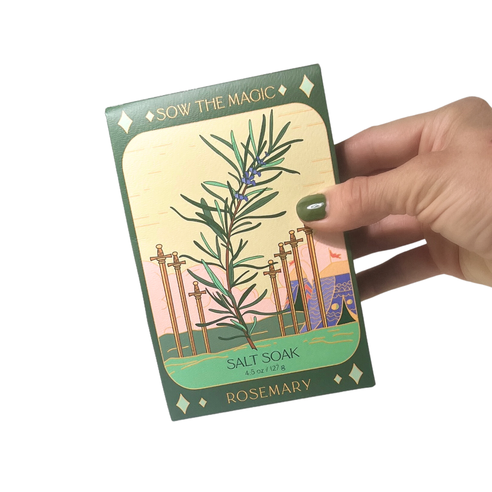 Rosemary Salt Soak tarot box held in hand with green nail polish, showcasing botanical rosemary artwork