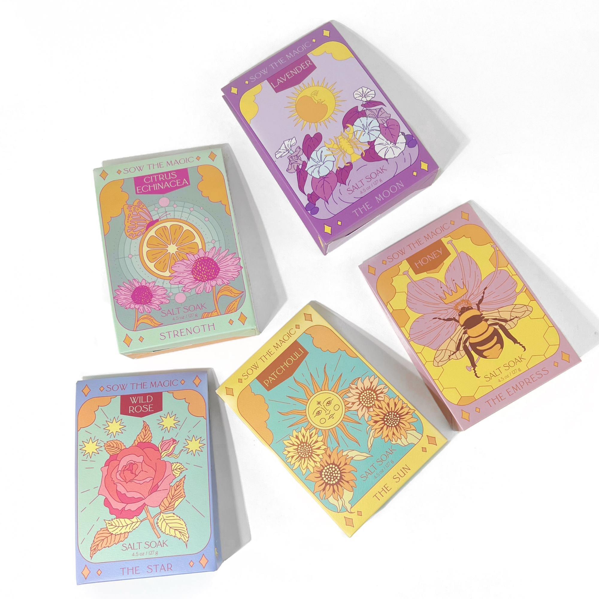 Flat lay of Sow the Magic tarot salt soaks featuring The Moon, The Sun, The Empress, The Star, and Strength card designs