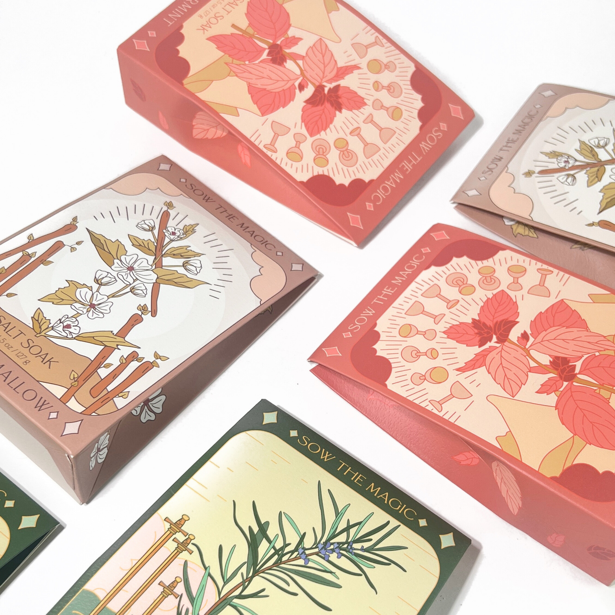 Flat lay of tarot-inspired salt soaks by Sow the Magic showing Peppermint, Marshmallow, and Rosemary box designs