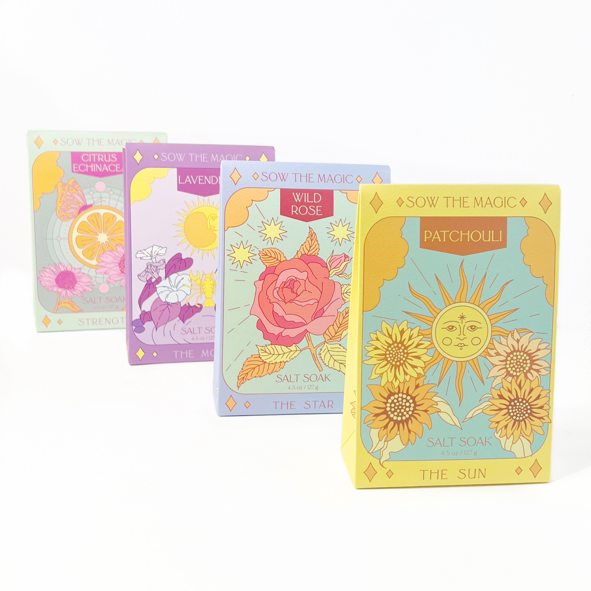 Row of Sow the Magic tarot salt soaks with colorful packaging featuring sun, rose, bee, and moon designs