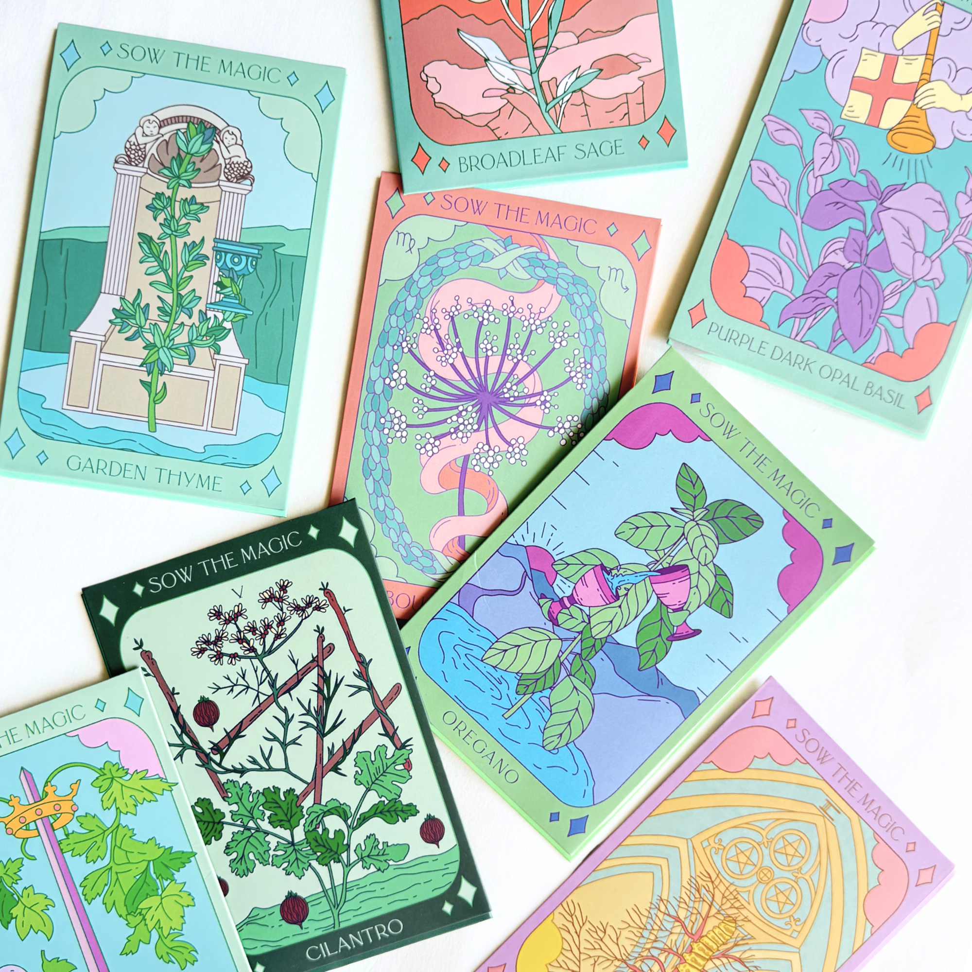 Overhead view of assorted Sow the Magic tarot herb seed packets featuring vibrant illustrated designs