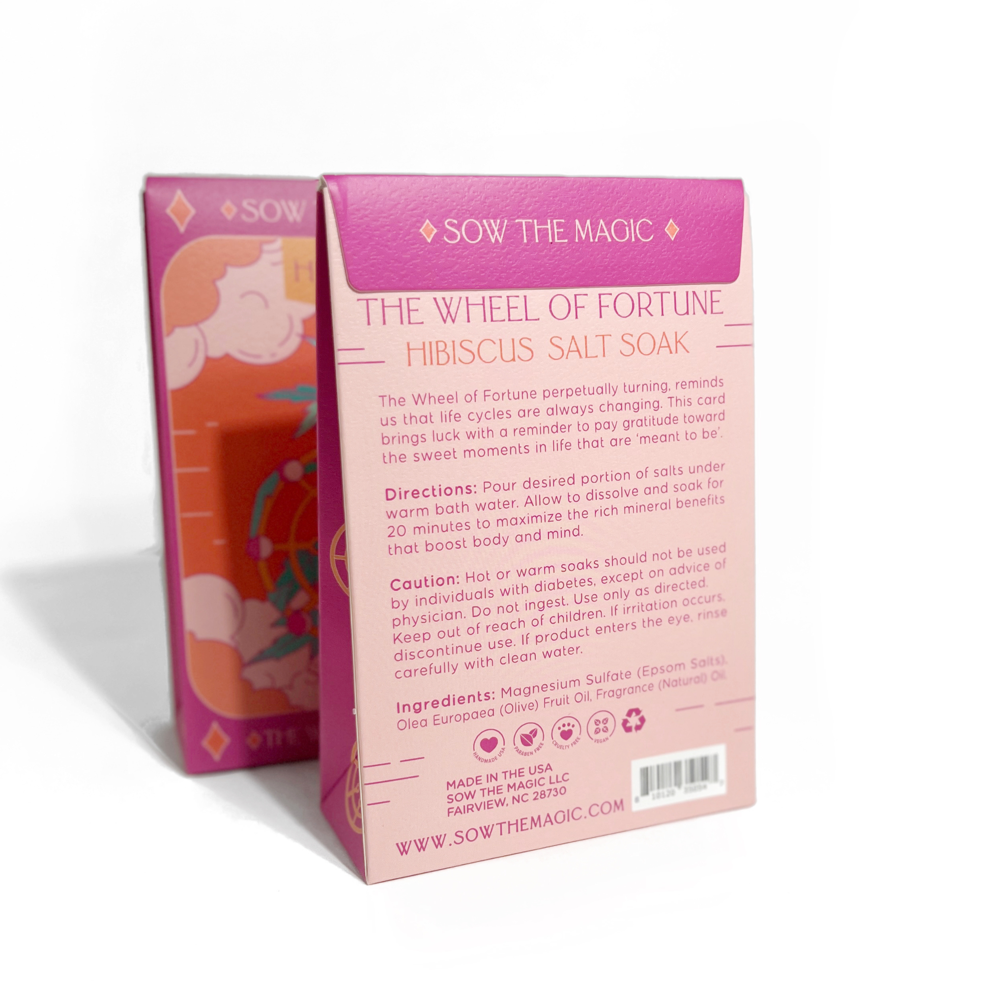 Angled view of Sow the Magic Hibiscus Salt Soak tarot-inspired packaging with pink and gold detailing