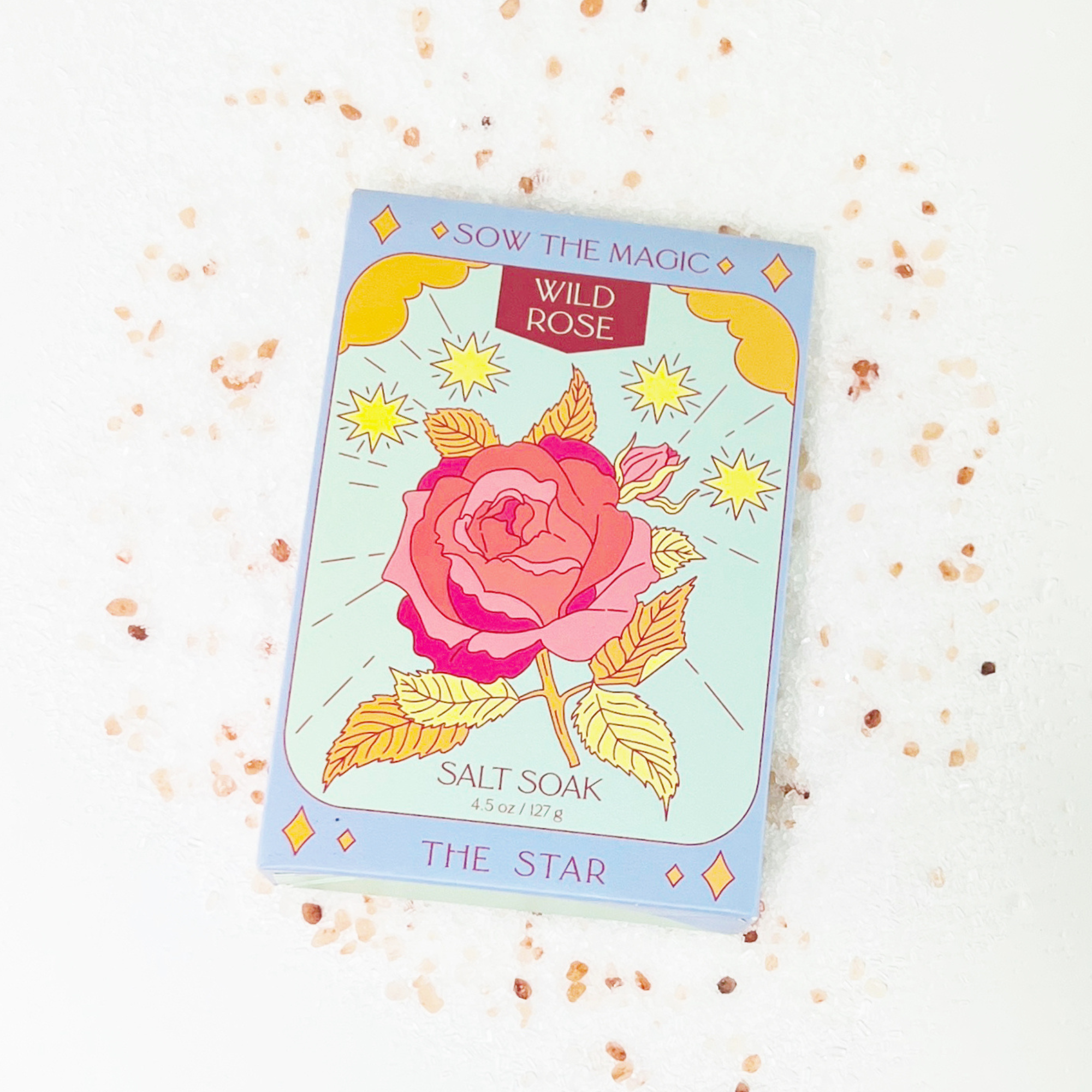 The Star Wild Rose Salt Soak tarot-inspired box surrounded by pink Himalayan salt crystals