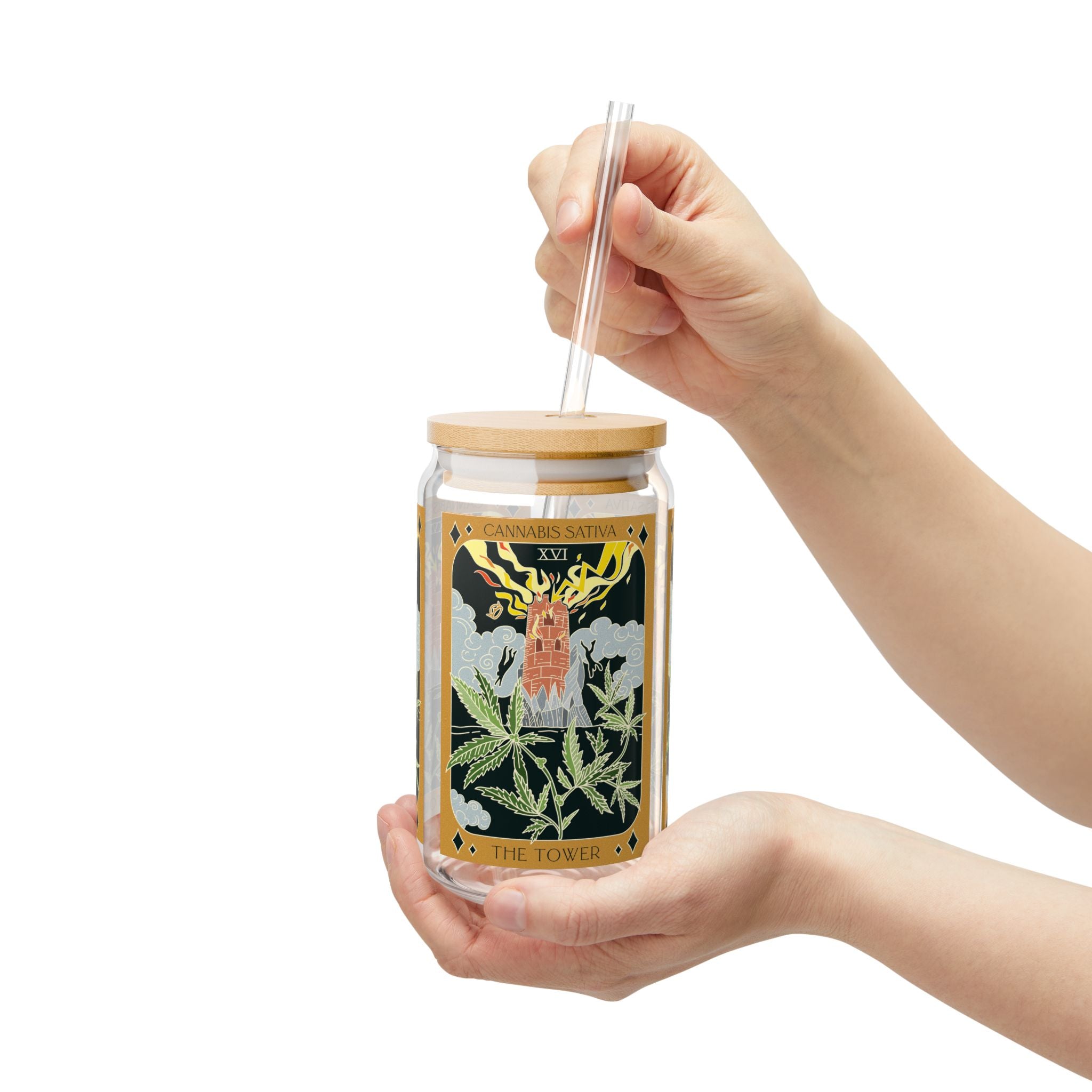 Hand holding The Tower Cannabis Sativa tarot glass tumbler with bamboo lid and reusable clear straw