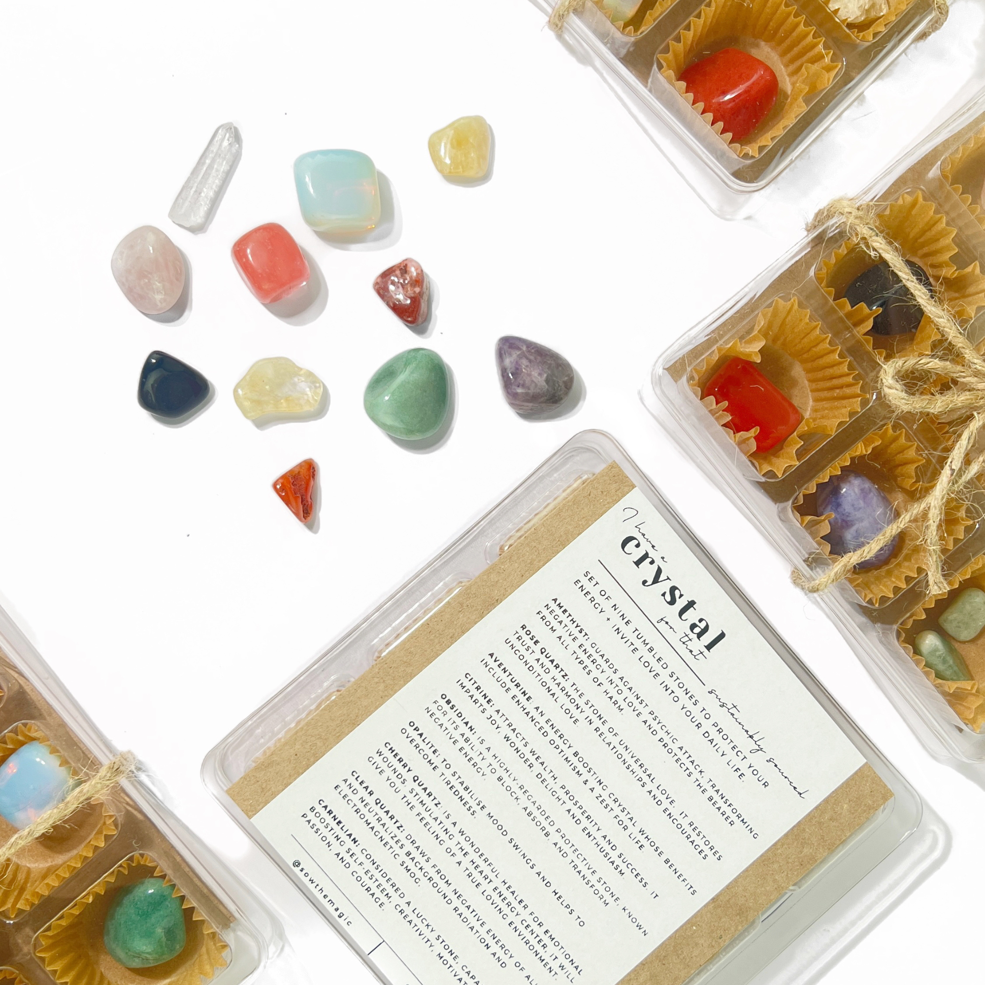Flat lay of colorful tumbled healing crystals including amethyst and rose quartz