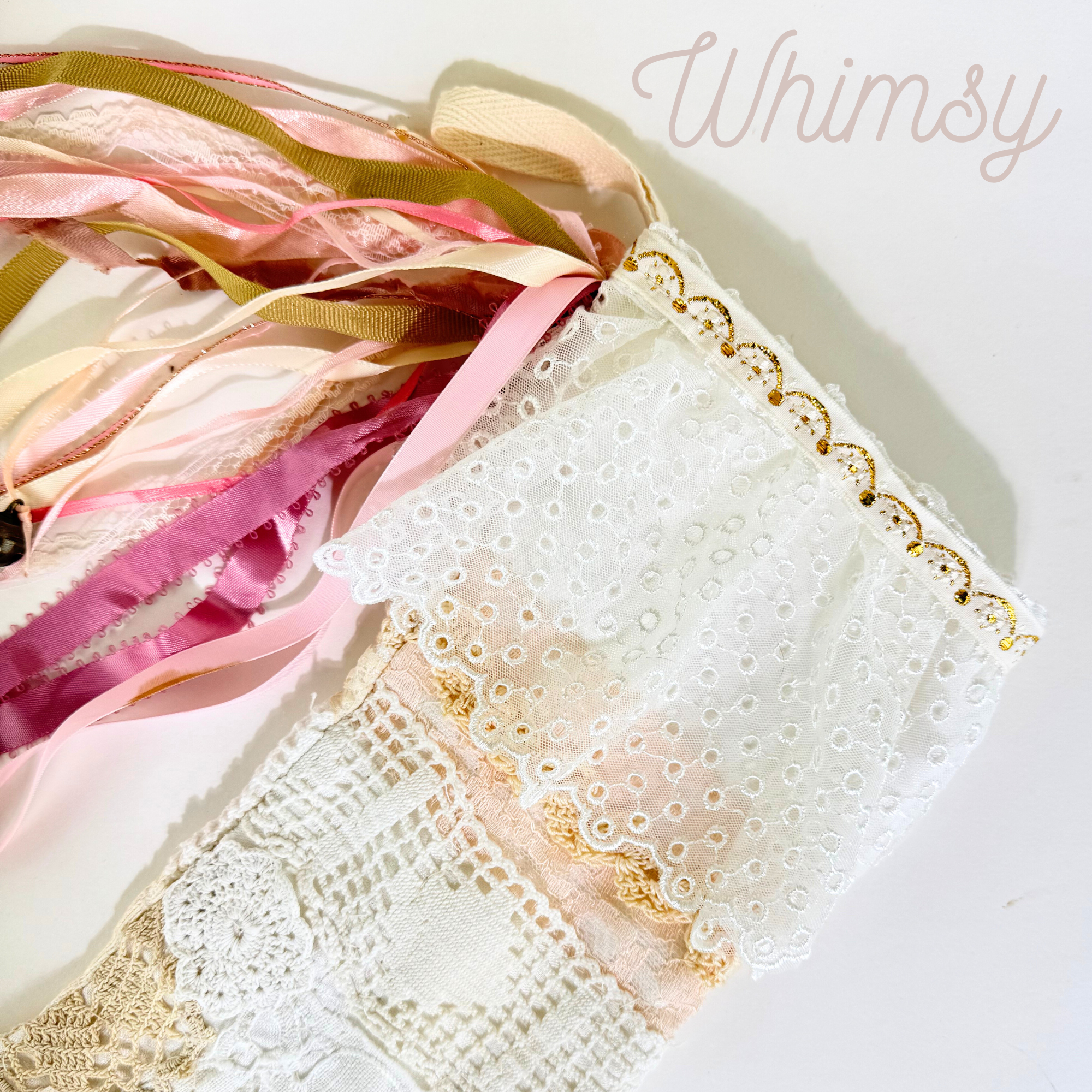 White lace Christmas stocking top with gold trim, eyelet lace, and cascading pink ribbon tassels