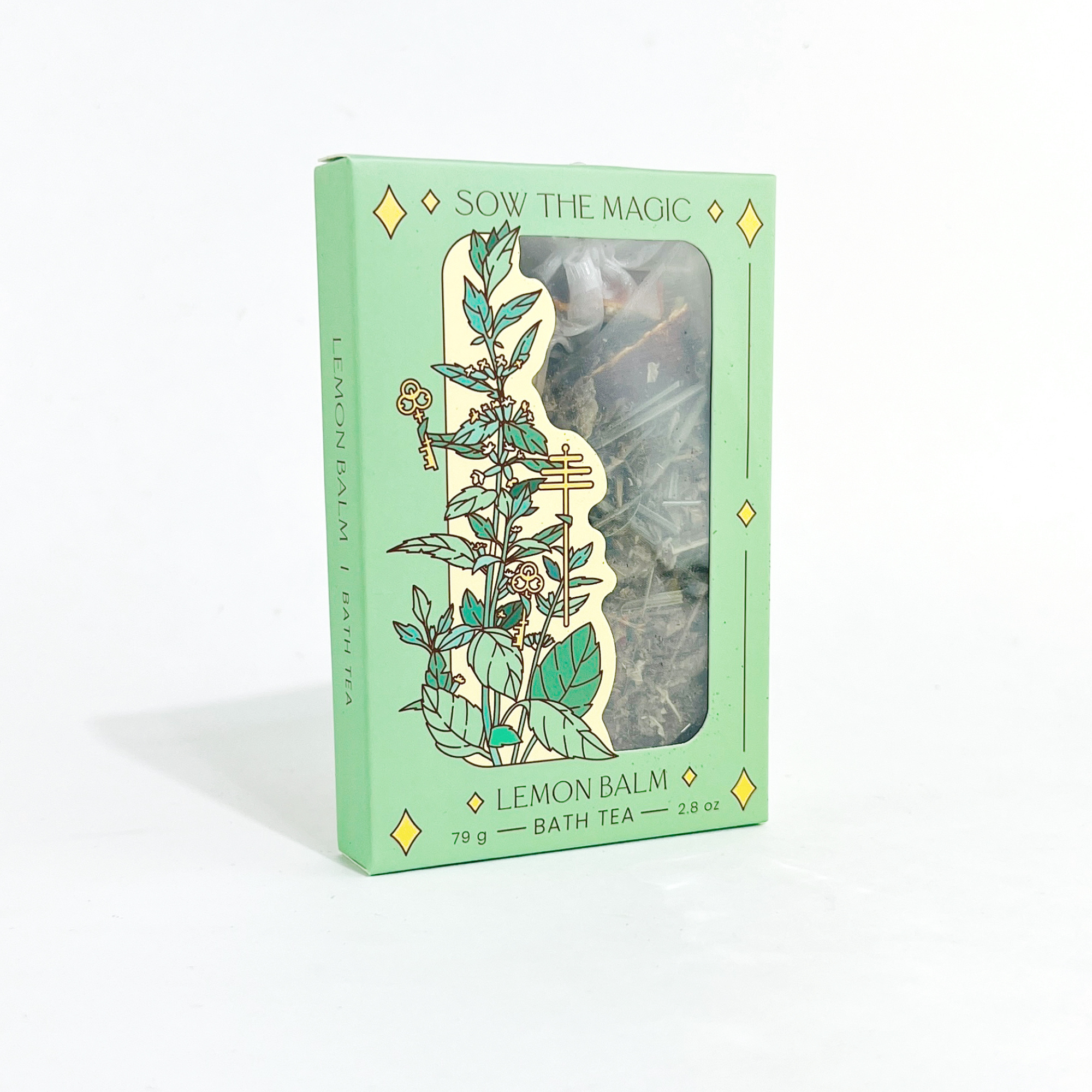 Lemon Balm Tarot Botanical Bath Tea Box by Sow the Magic with mint green packaging and herbal blend visible through window.