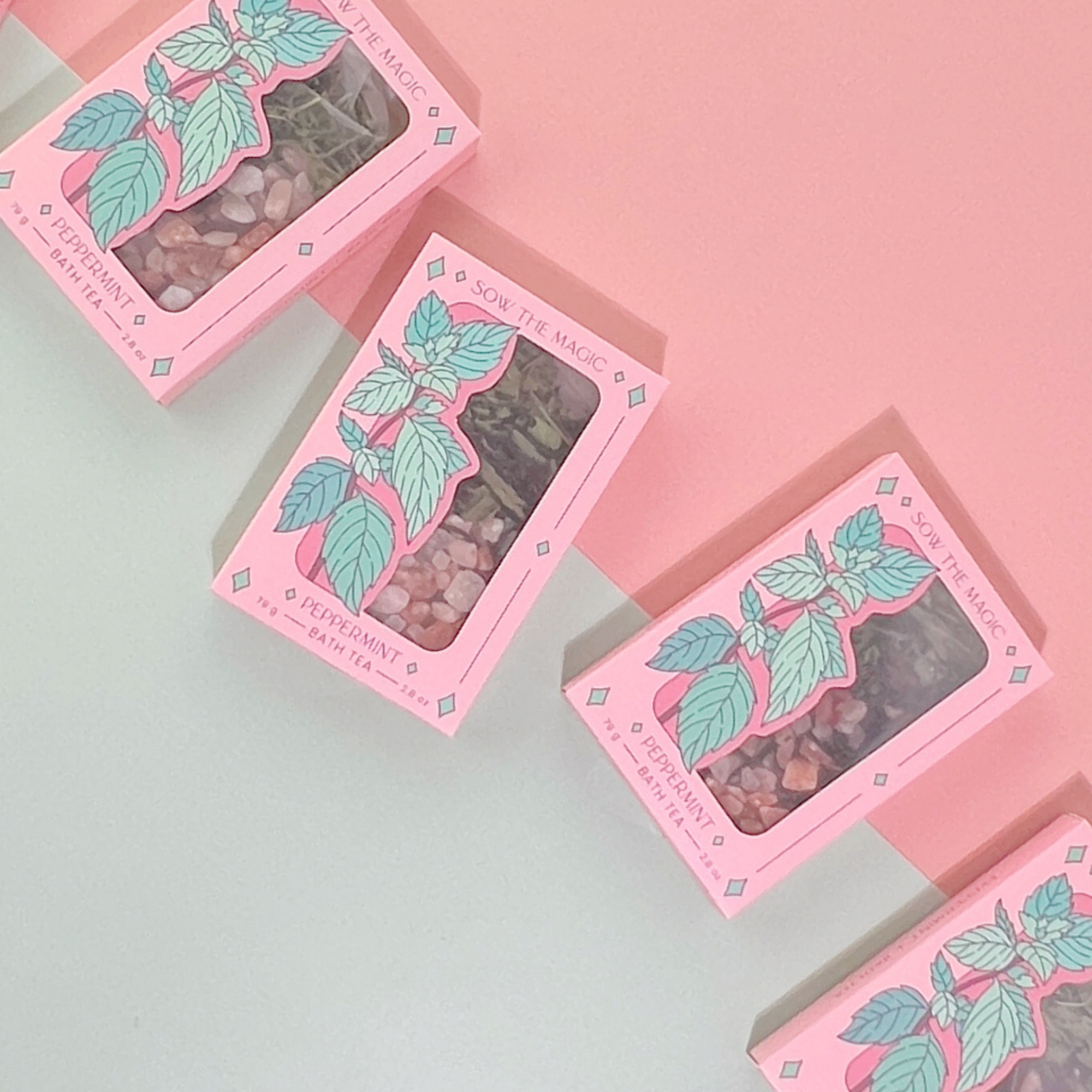 Multiple Peppermint Tarot Botanical Bath Tea Boxes arranged on pink and mint background with fresh, vibrant packaging.
